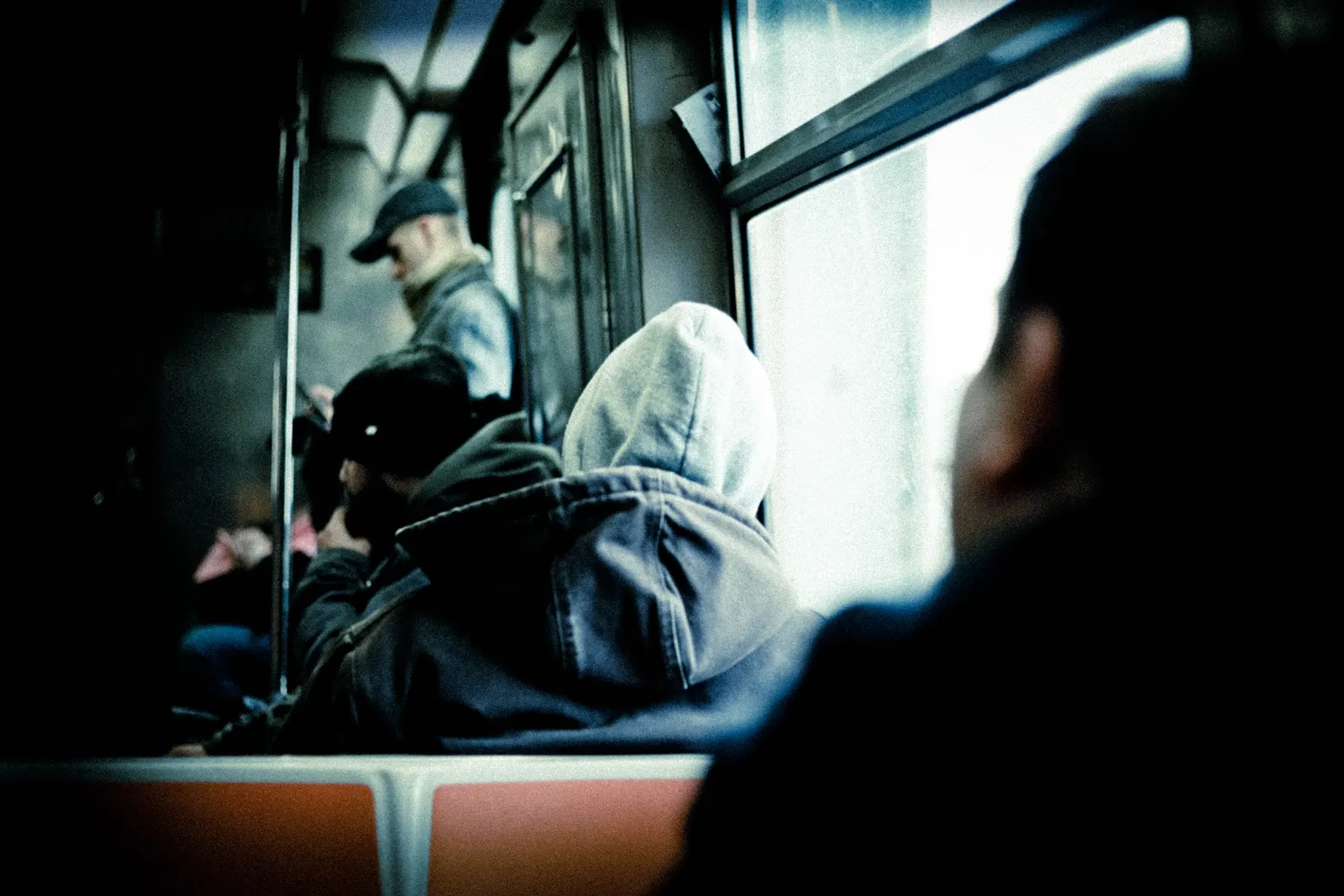 Hooded passenger on a subway train, from Polyphony