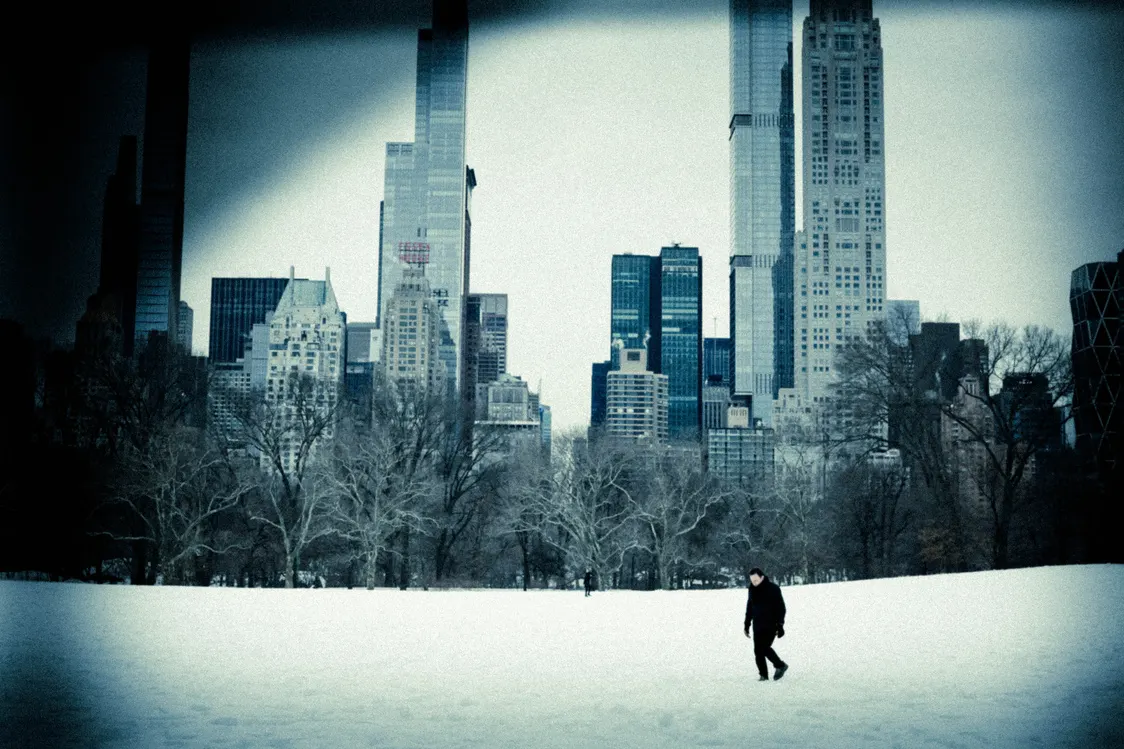A lone figure in snow beneath the Manhattan skyline, from Polyphony