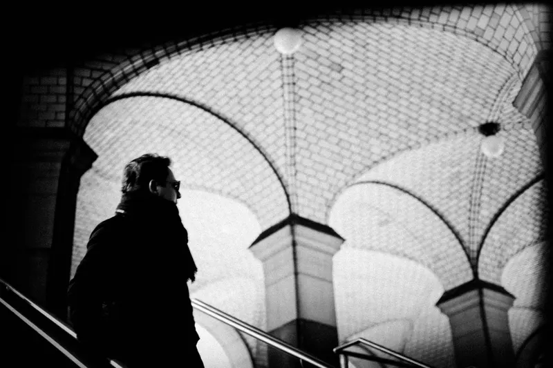 A figure beneath vaulted arches, from Polyphony